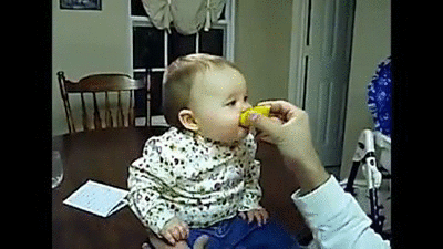 Gif of a baby eating a lemon.